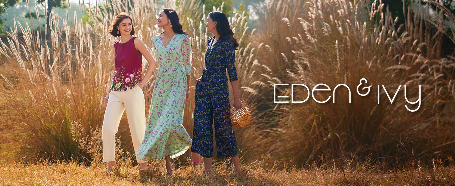 Three women in a field of tall grass, with the brand’s logo