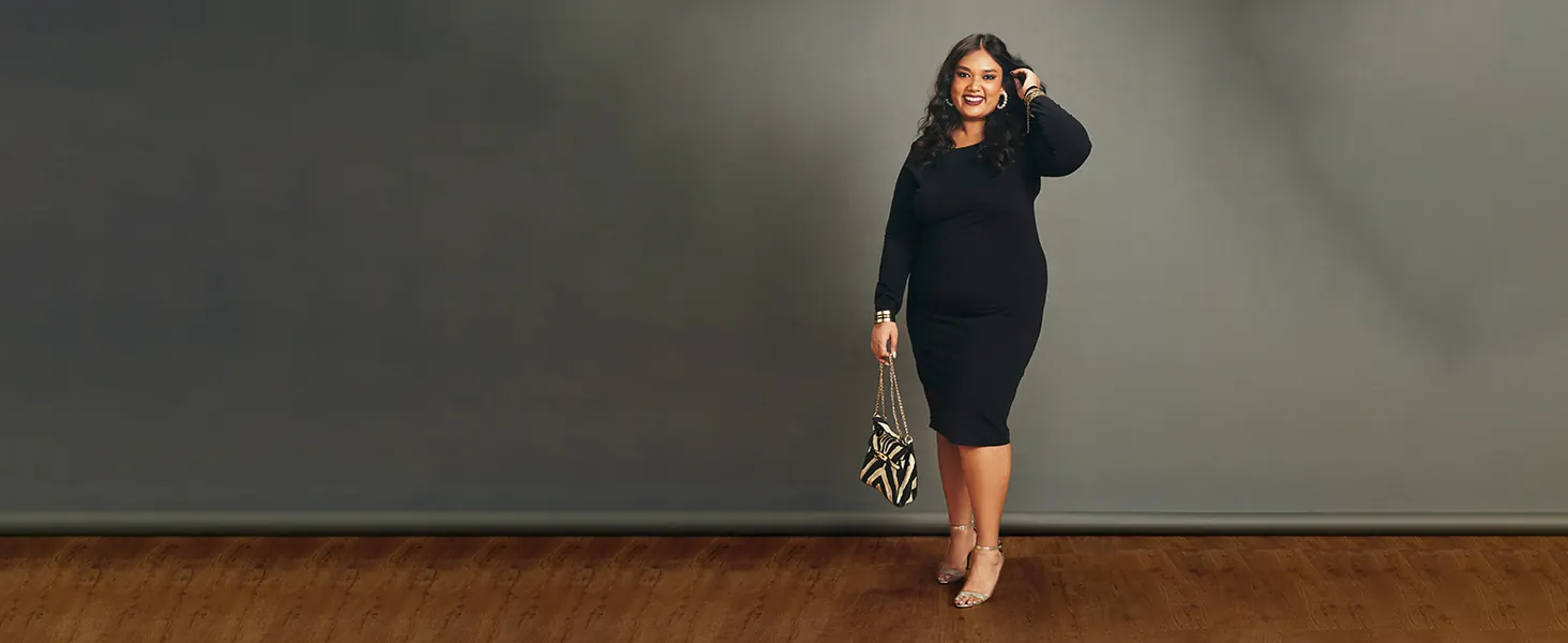 A woman in a black dress, standing tall