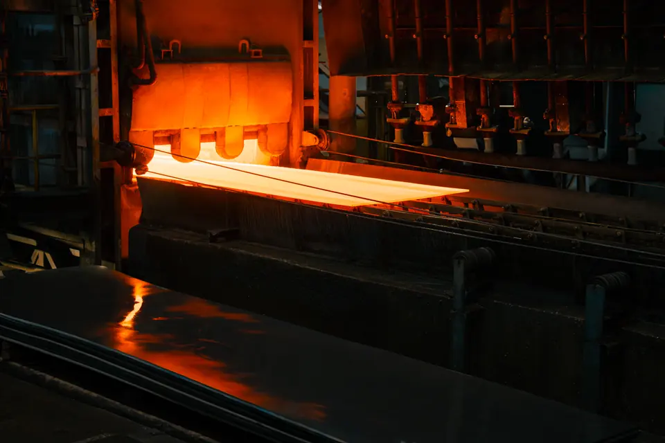 A red-hot steel plate lighting up the rollers below it