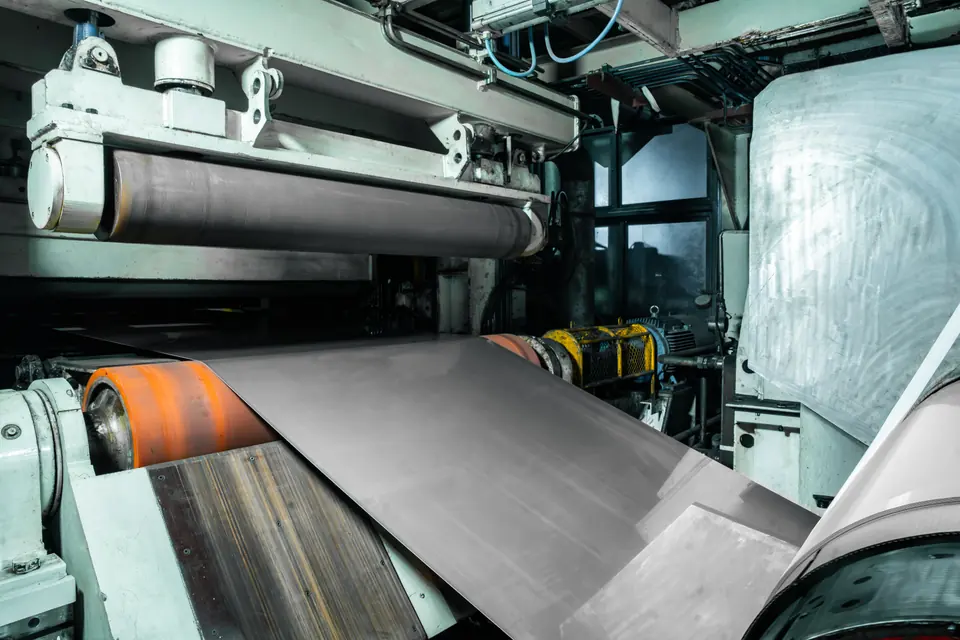 Steel sheet running over rollers, seen close up