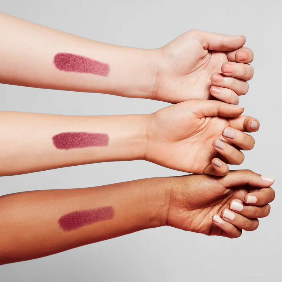 One lipstick shade swatched on three different skin tones