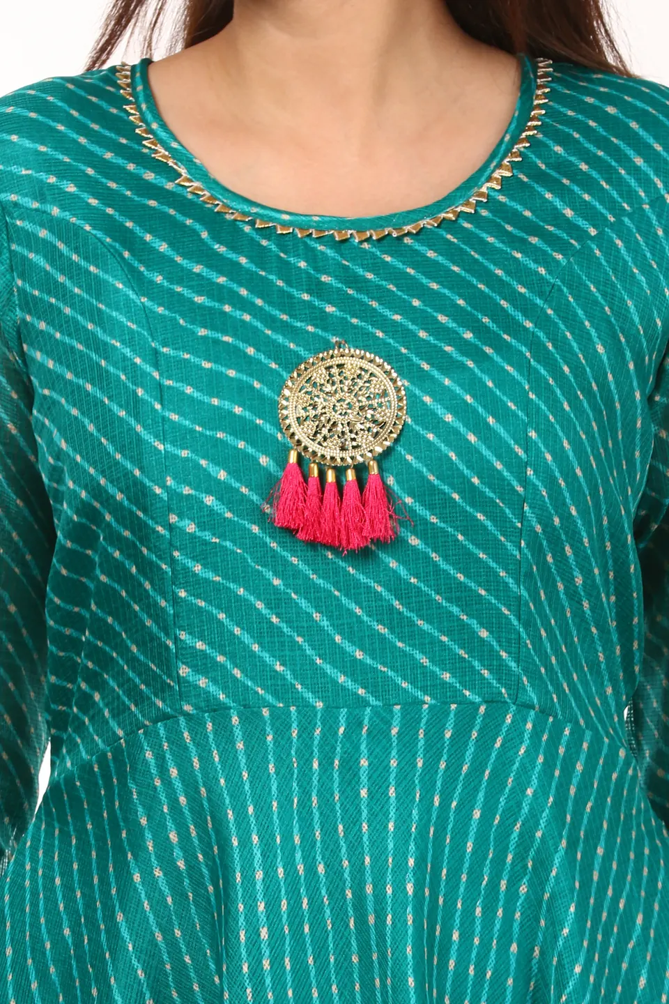 Close-up of the embroidered neckline and tasselled medallion on a teal kurta