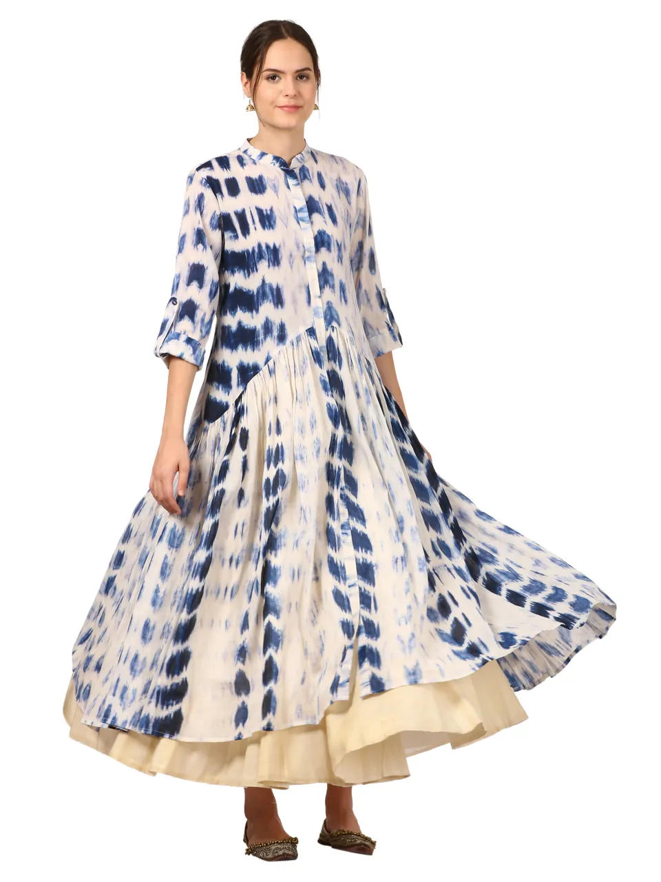 A model twirling in a blue and white tie-dyed anarkali, on white