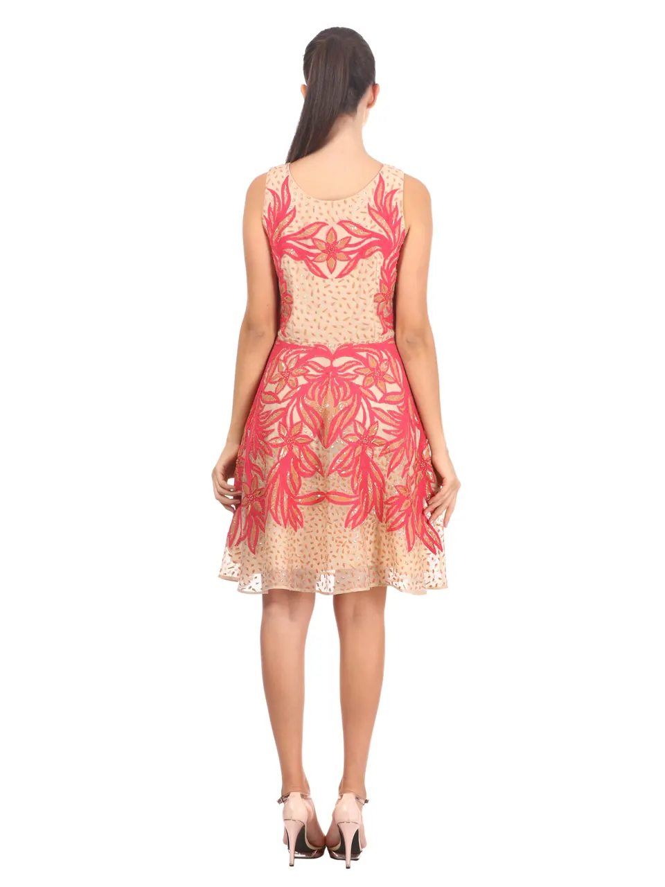 Back view of the pink-embroidered lace dress on the model, on white