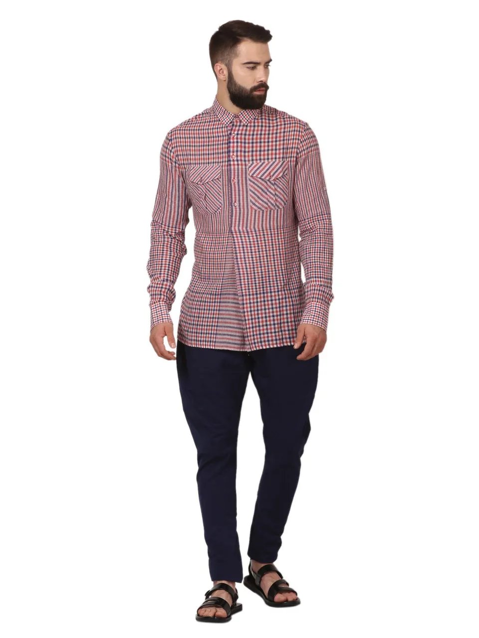 A male model in a red checked shirt and navy trousers, on white