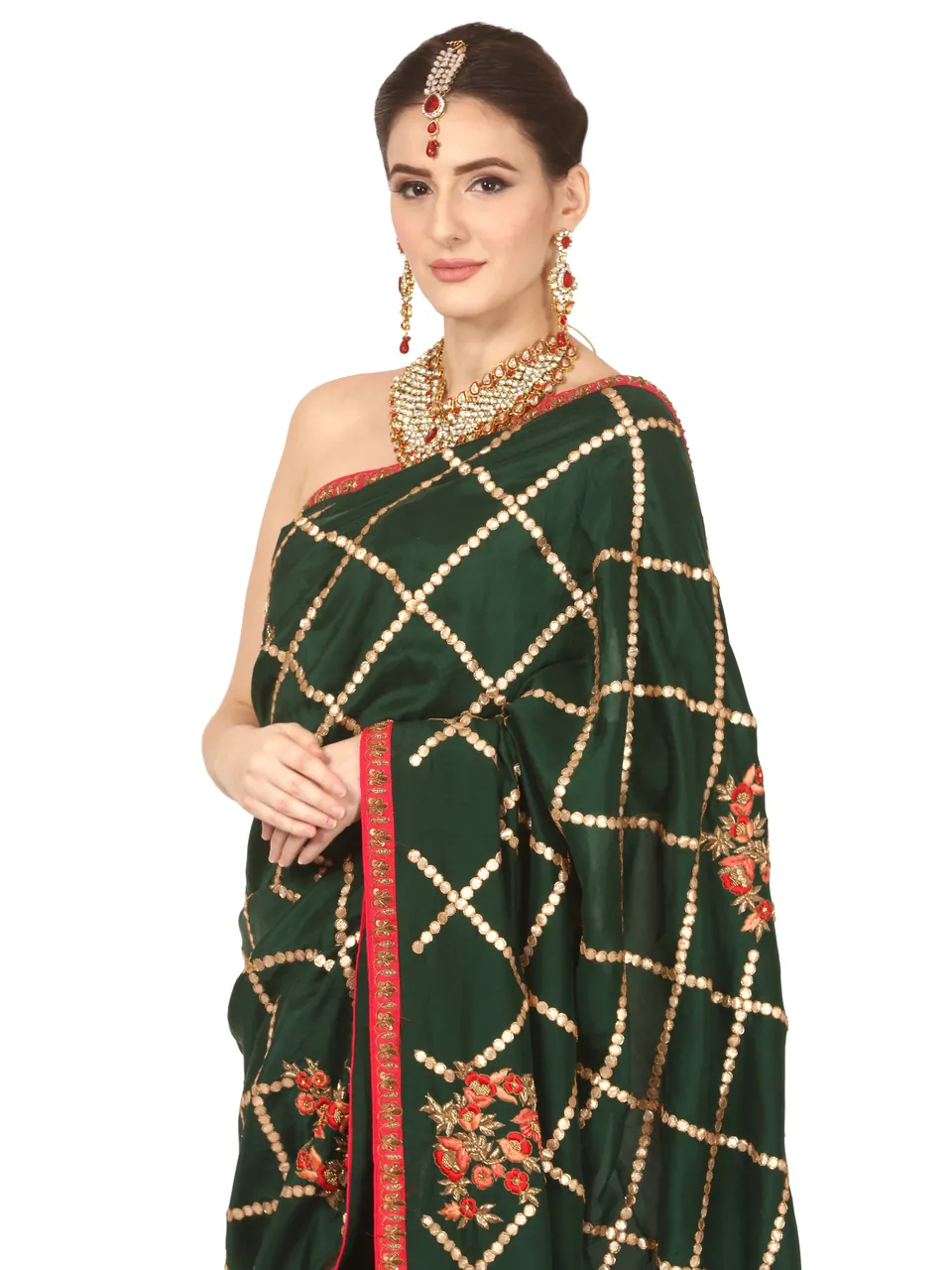 The same green saree up close: its gold checks, embroidered border and the model’s jewellery