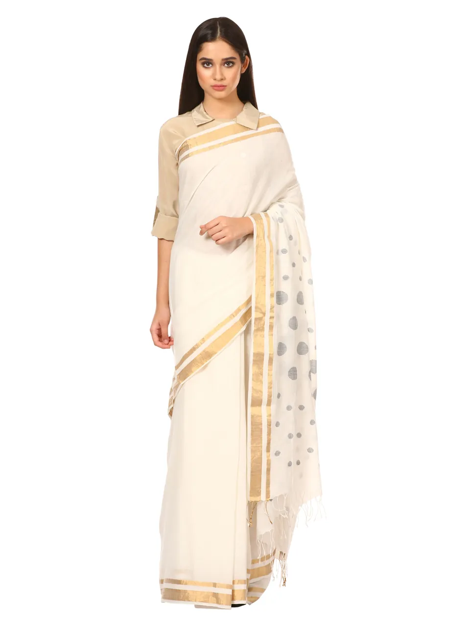 A model in a white saree with a gold border and a dotted pallu, on white
