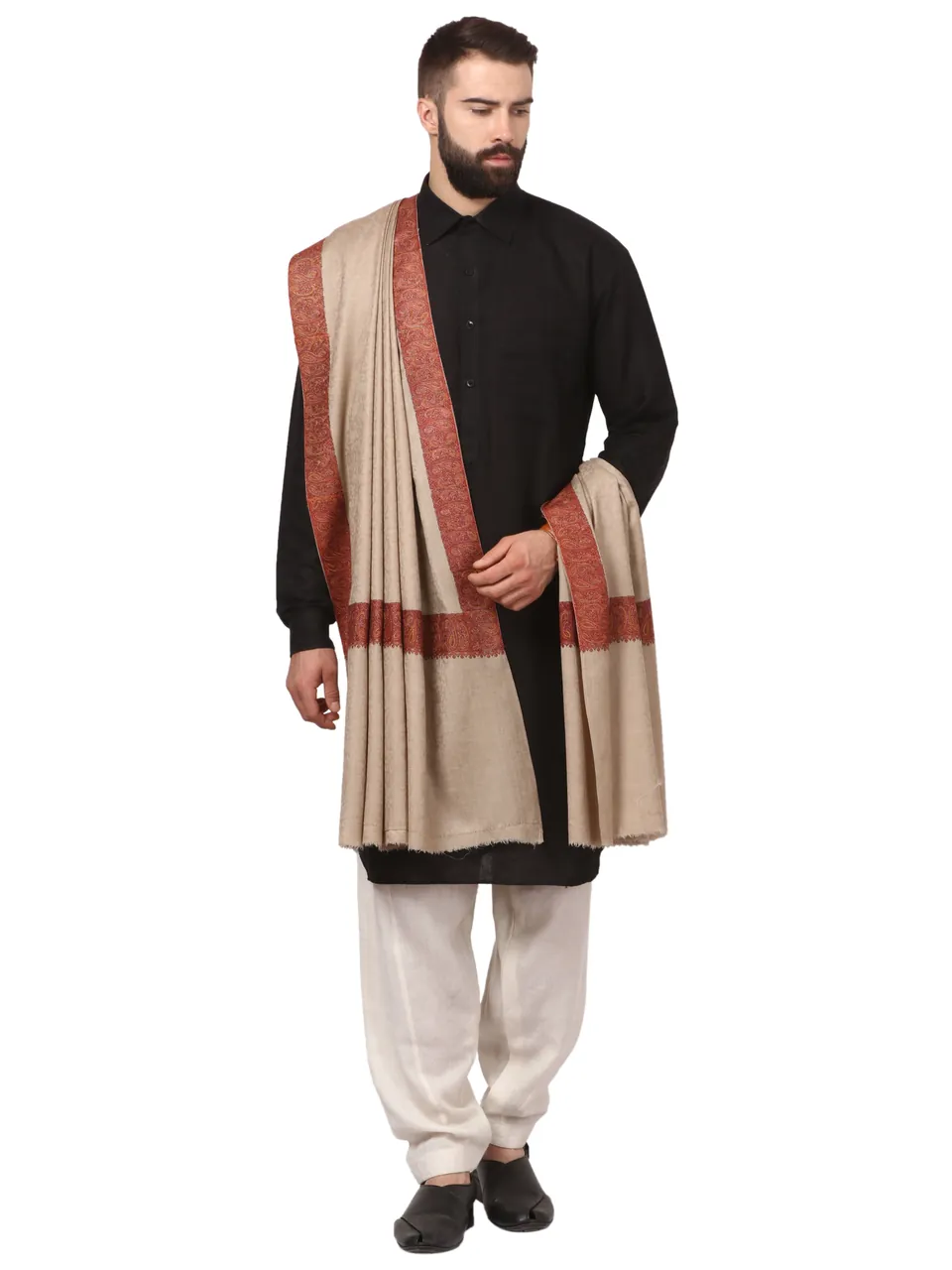 A male model in a black kurta with a beige shawl over his shoulder, on white