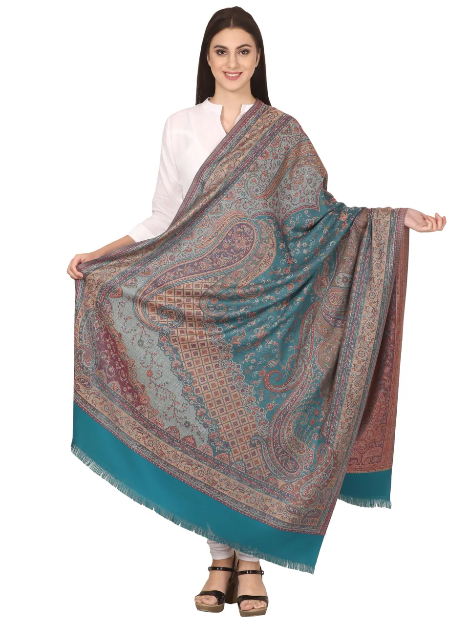 A model holding open a teal and grey paisley shawl, on white