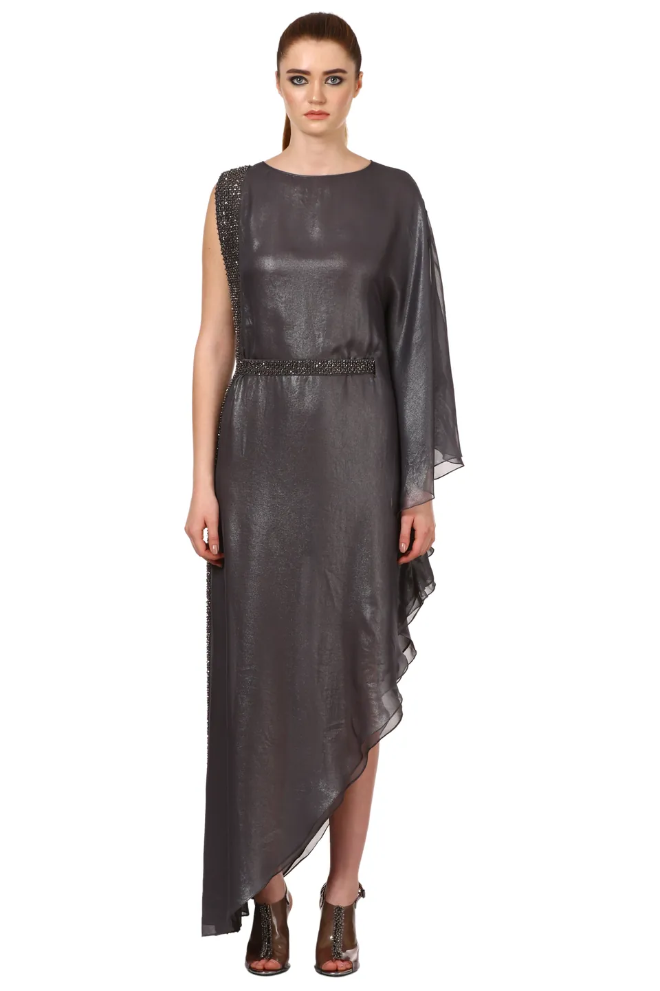 A model in a charcoal draped gown with an asymmetric hem, on white
